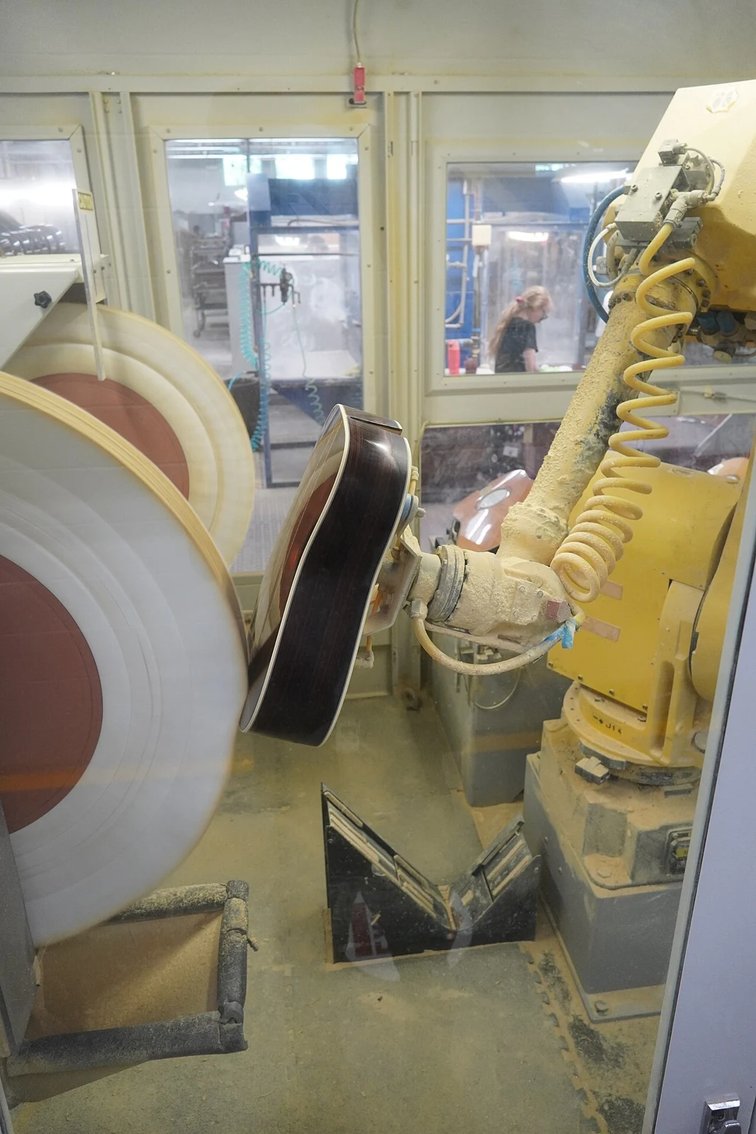 An industrial robot polishing a guitar