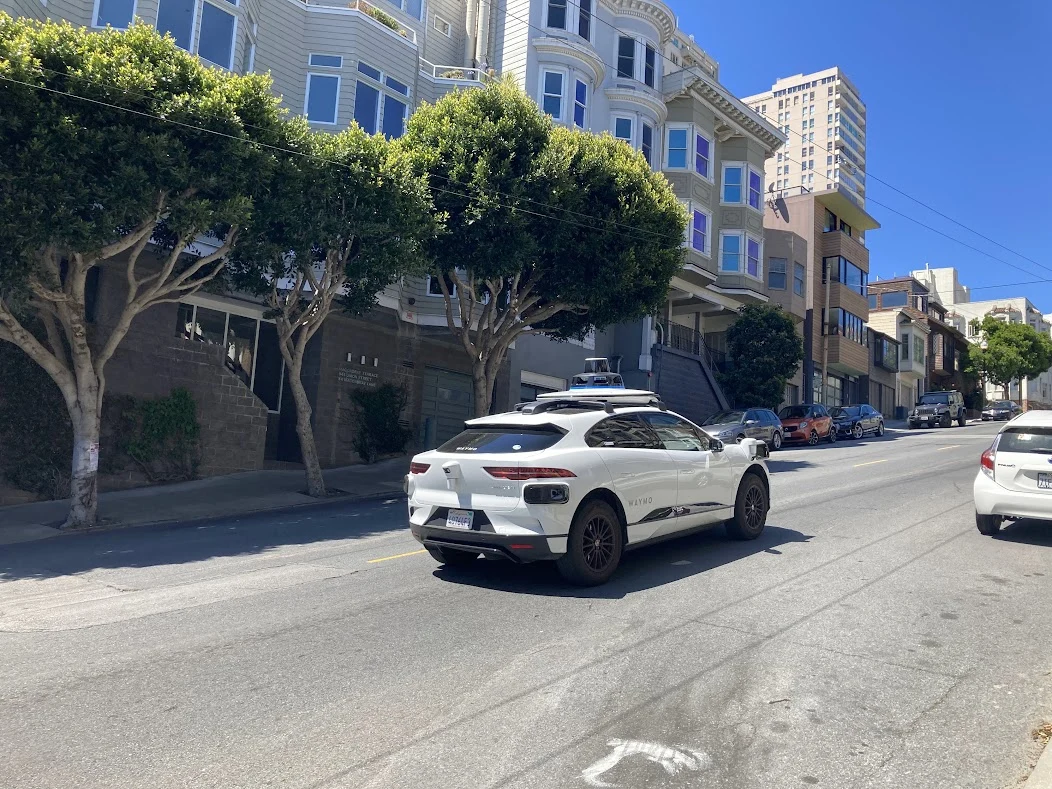 A Waymo autonomous taxi on a city street